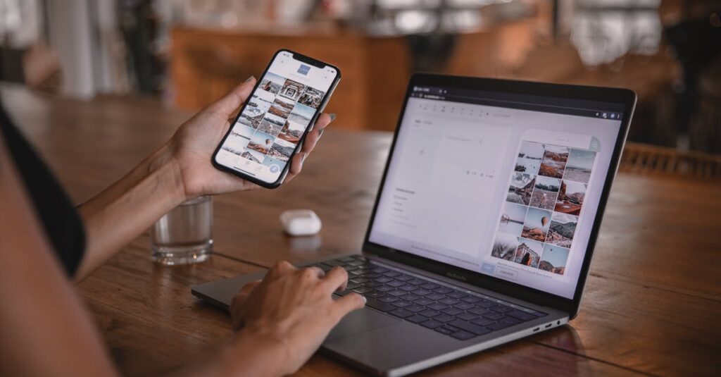 Woman edits social media content on phone and laptop at a cafe in Bali.